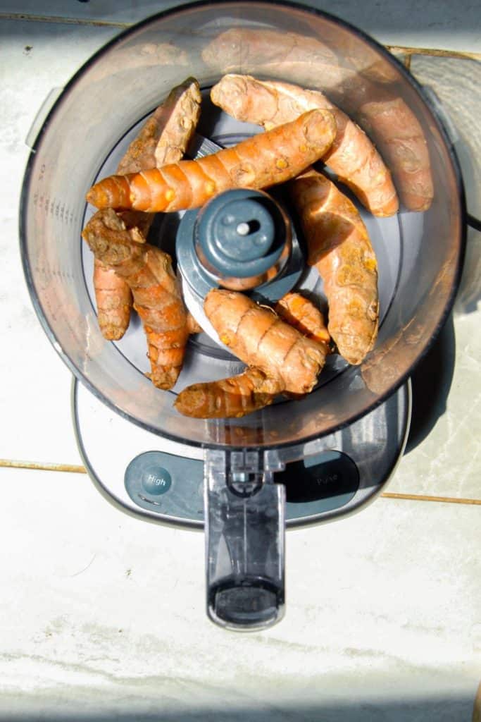 Fresh Turmeric root in a food processor to make a DIY tincture.