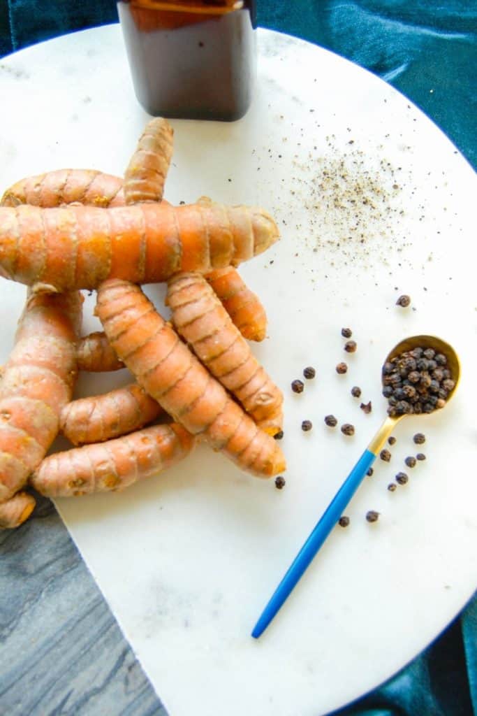 Fresh turmeric and black pepper to DIY a turmeric tincture.