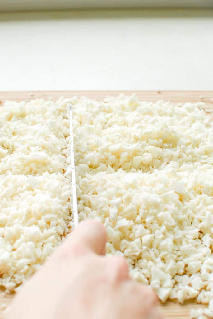 making cauliflower rice without a food processor, chopping cauliflower with a knife instead.