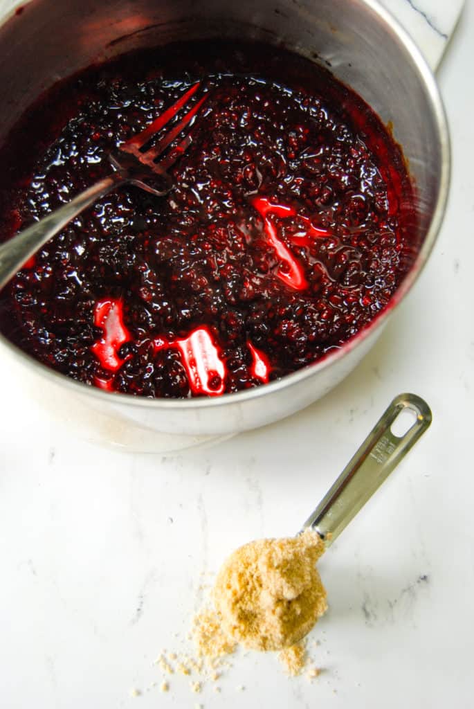 mashed blackberries to make blackberry jam
