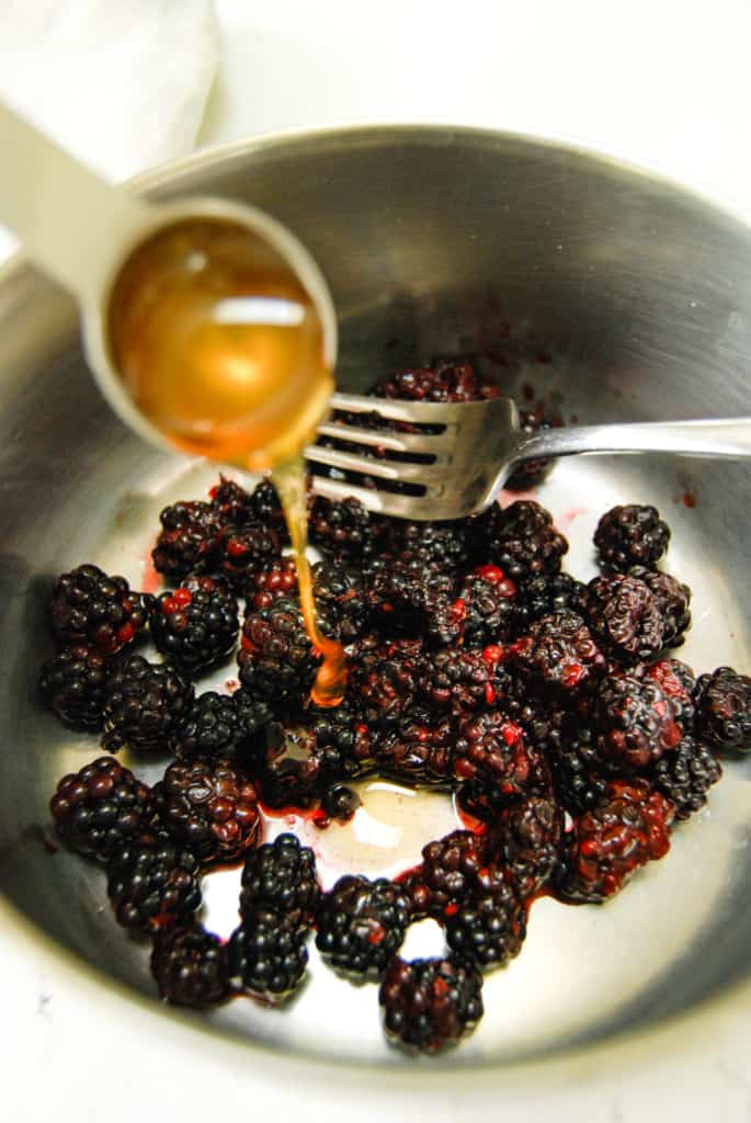 a pot of blackberries with honey