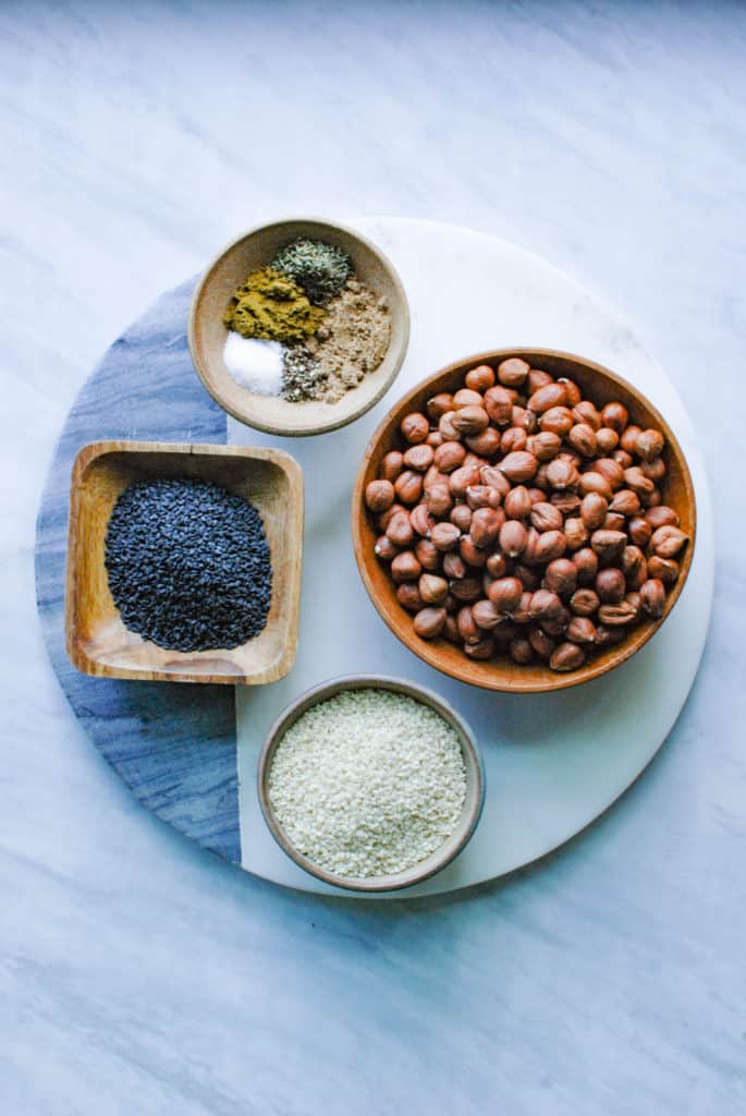 ingredients to make dukkah arranged on a countertop
