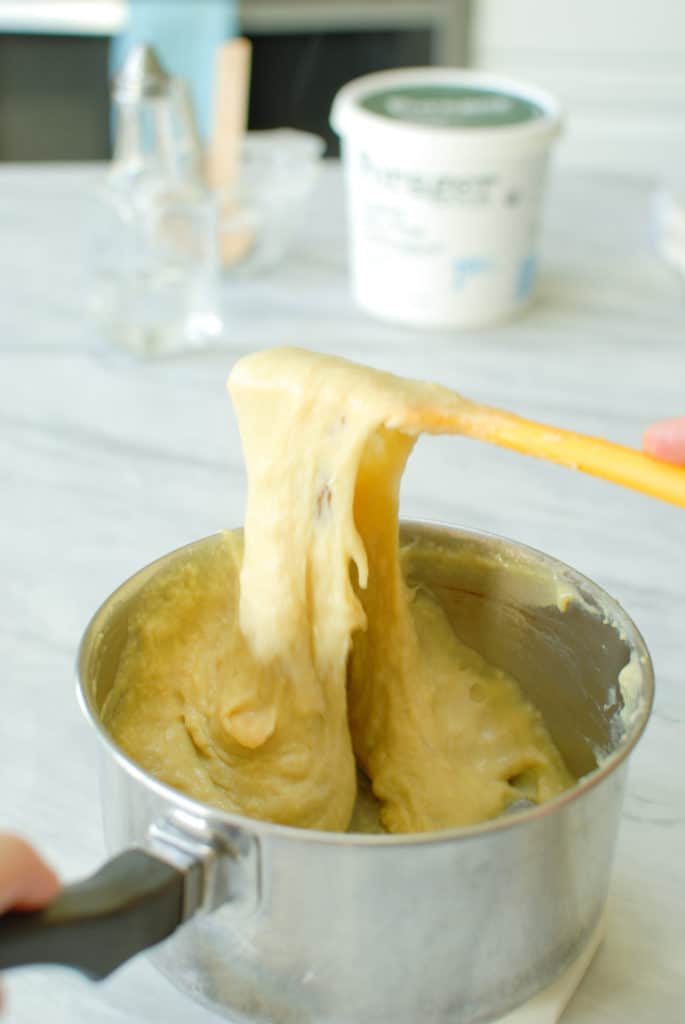 a spatula showing a cheese pull on homemade vegan cheese
