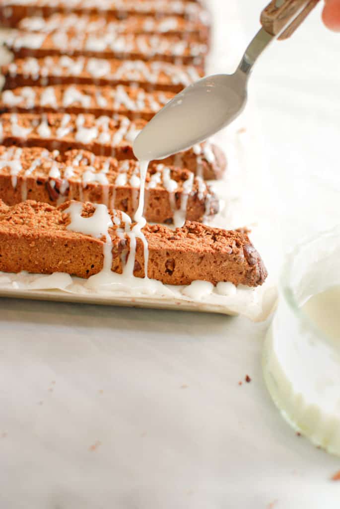 a tray of biscotti getting iced.