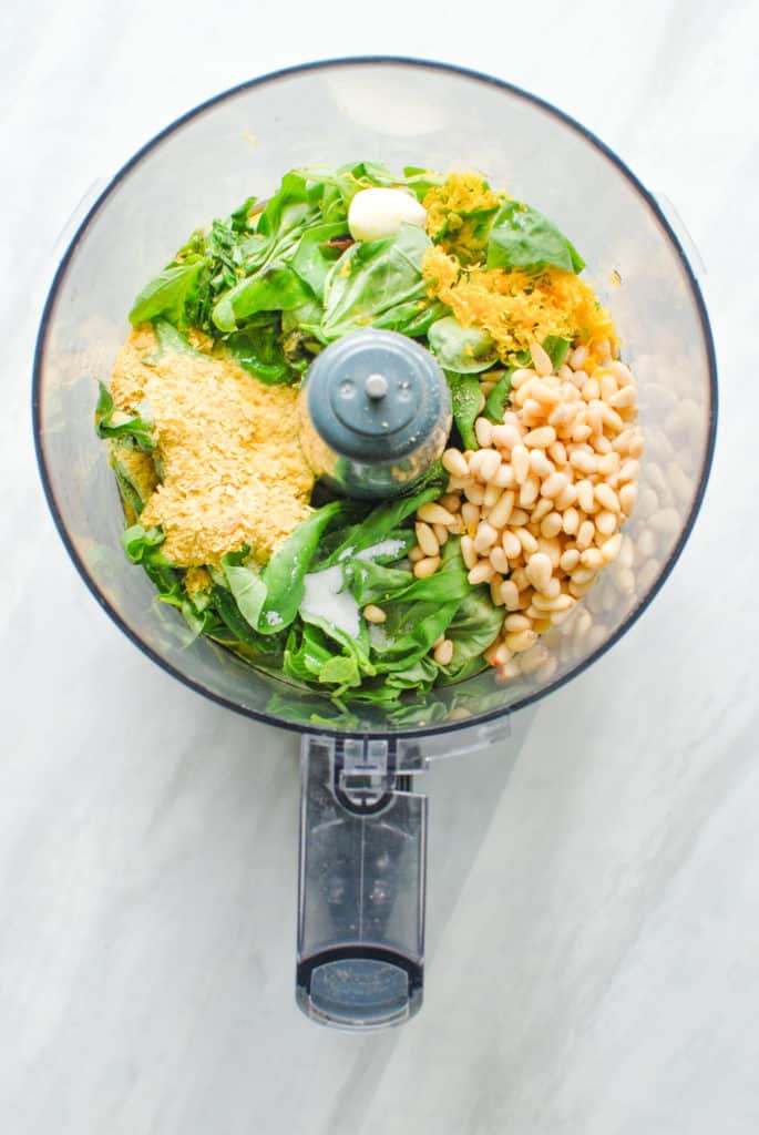 ingredients for meyer lemon pesto in a food processor base.