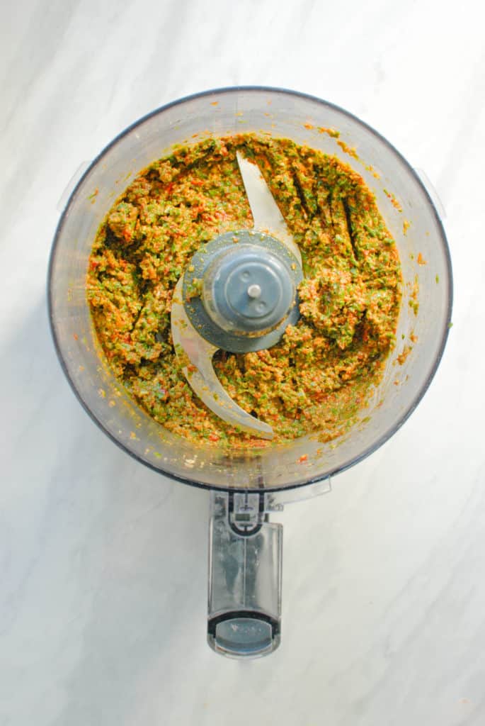 food processor with fresh vegan sundried tomato pesto sauce