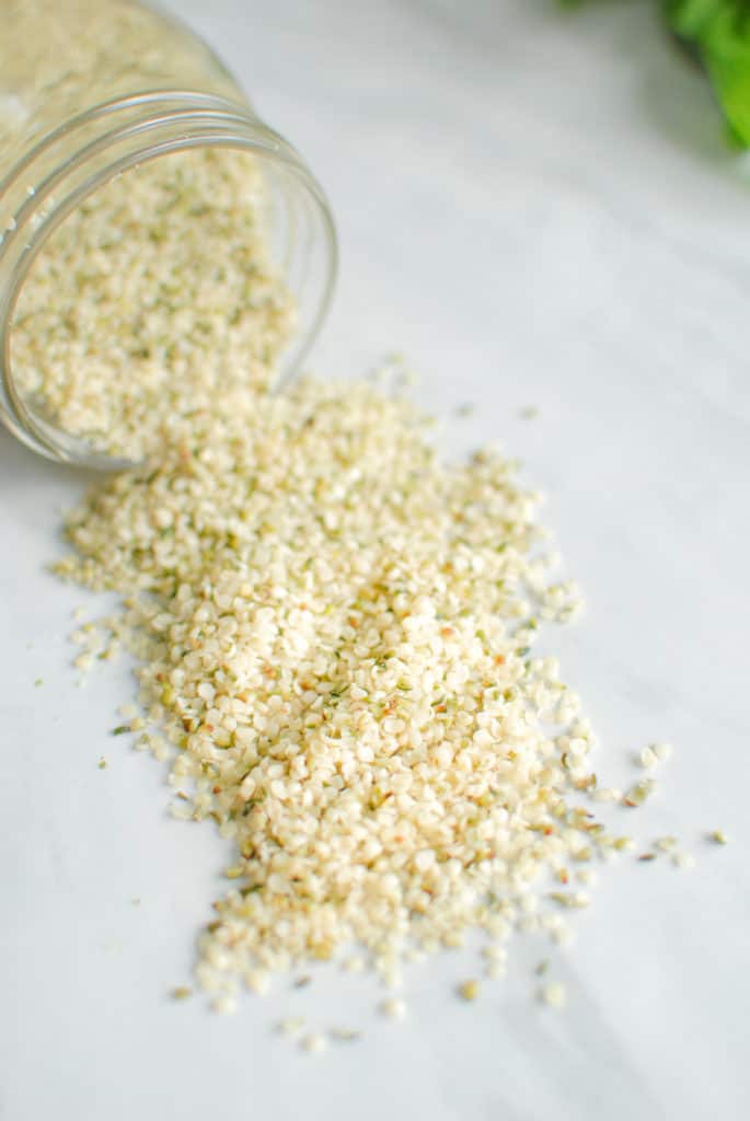 A jar of hemp seeds to use in making nut free & dairy free pesto.