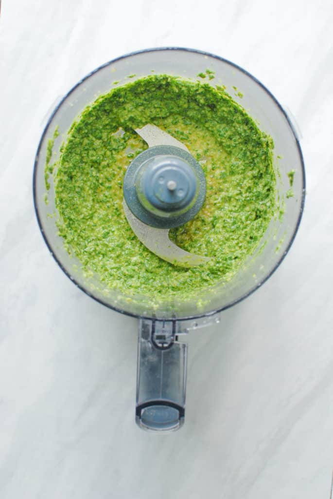 Fresh, homemade vegan nut-free pesto in a food processor.