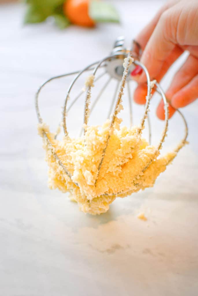 Butter and sugar on a mixing whisk before creaming.