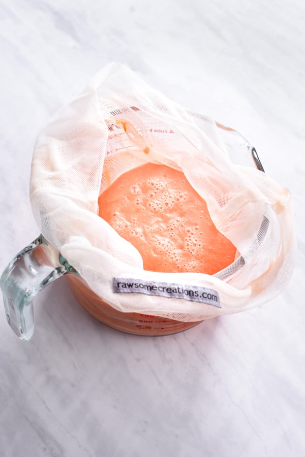 straining fresh grapefruit juice