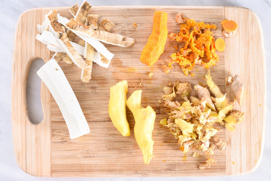 turmeric, ginger, and horseradish on a cutting board