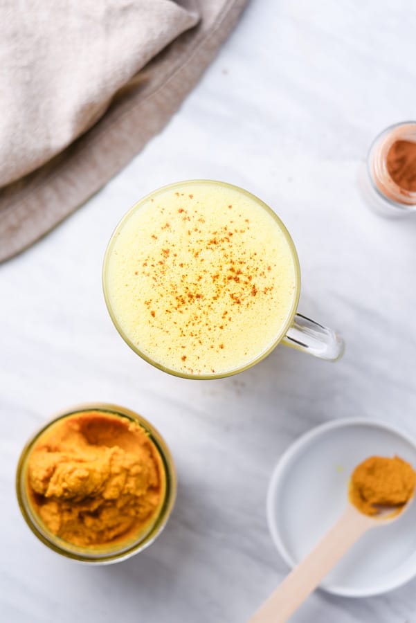 overhead shot of a golden milk tea made using turmeric paste