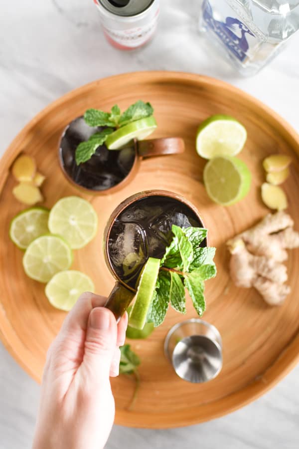 hand with Ingredients to make a mexican mule