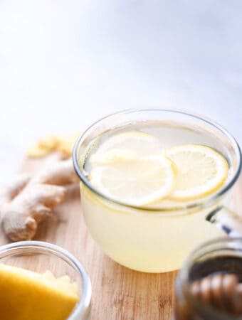 a cup of lemon tea on a cutting board