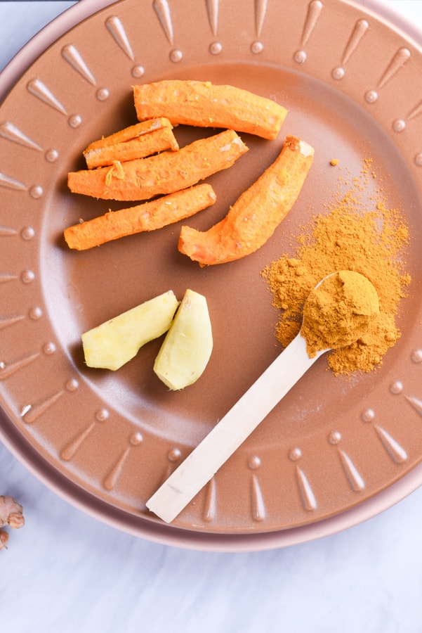 fresh turmeric and ginger on a plate