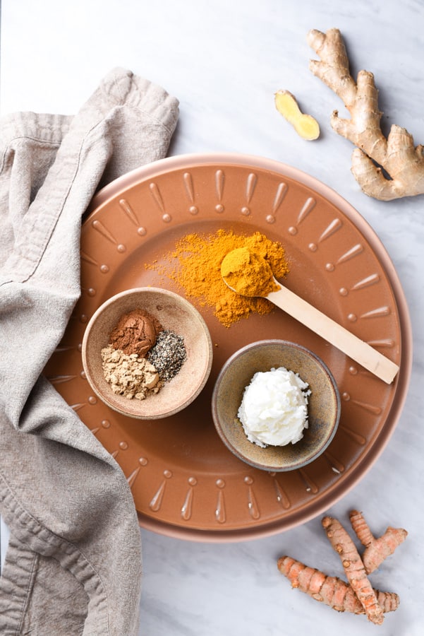 ingredients for turmeric paste on a plate