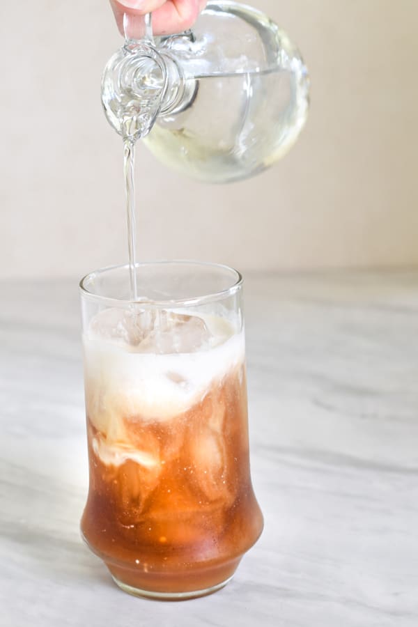 xylitol syrup being poured into coffee