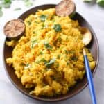 a platter of turmeric rice with limes