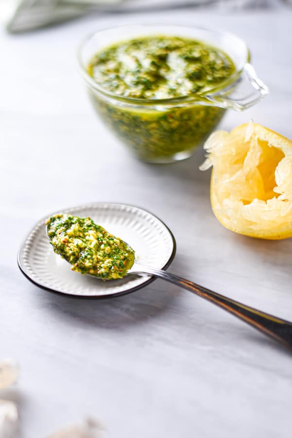 a spoon overflowing with parsley pesto