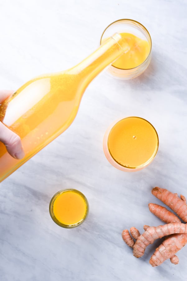 bright orange turmeric shots on the counter