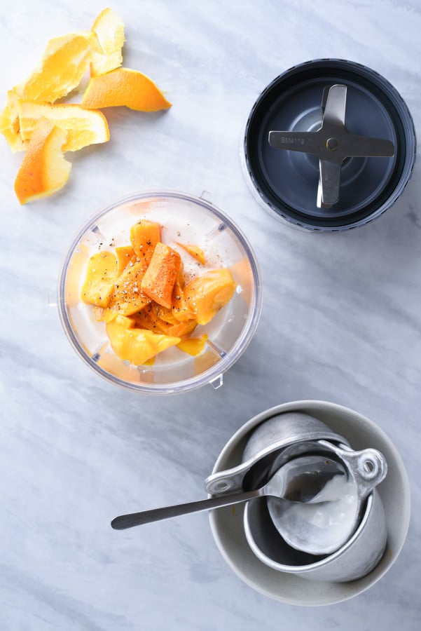 fresh turmeric, mango, and yogurt in a nutribullet