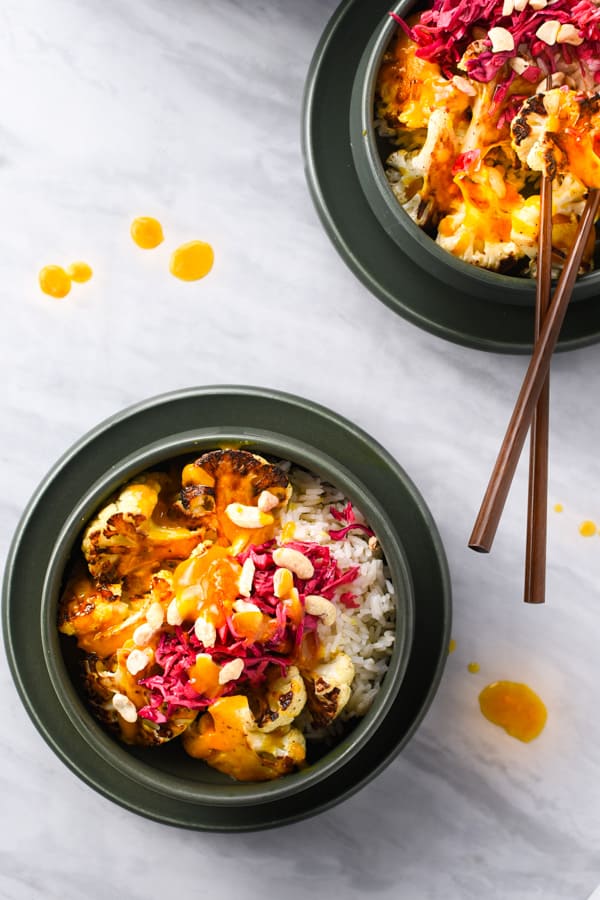 Overhead shot of 2 orange cauliflower bowls