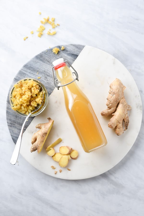 Overhead shot of fresh ginger and ginger syrup