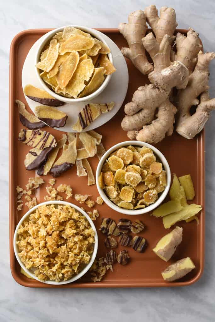 3 types of candied/crystallized ginger shown in 3 different bowls: slices, coins, and diced.