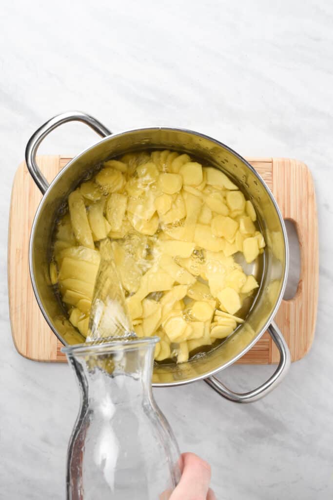 Ginger slices in a pot of boiling water