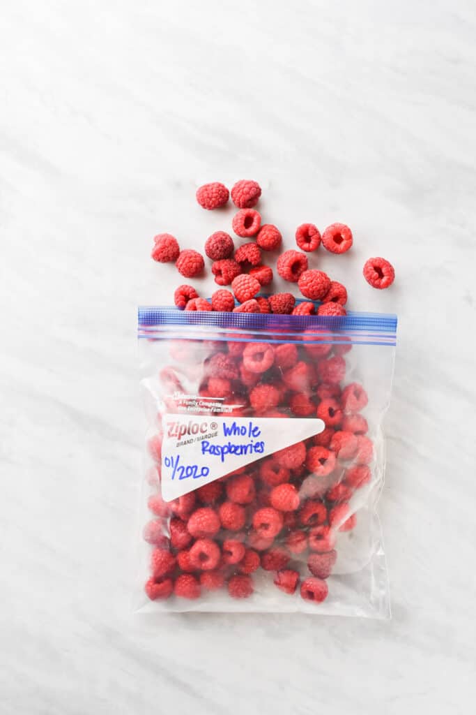 A plastic bag with frozen raspberries inside