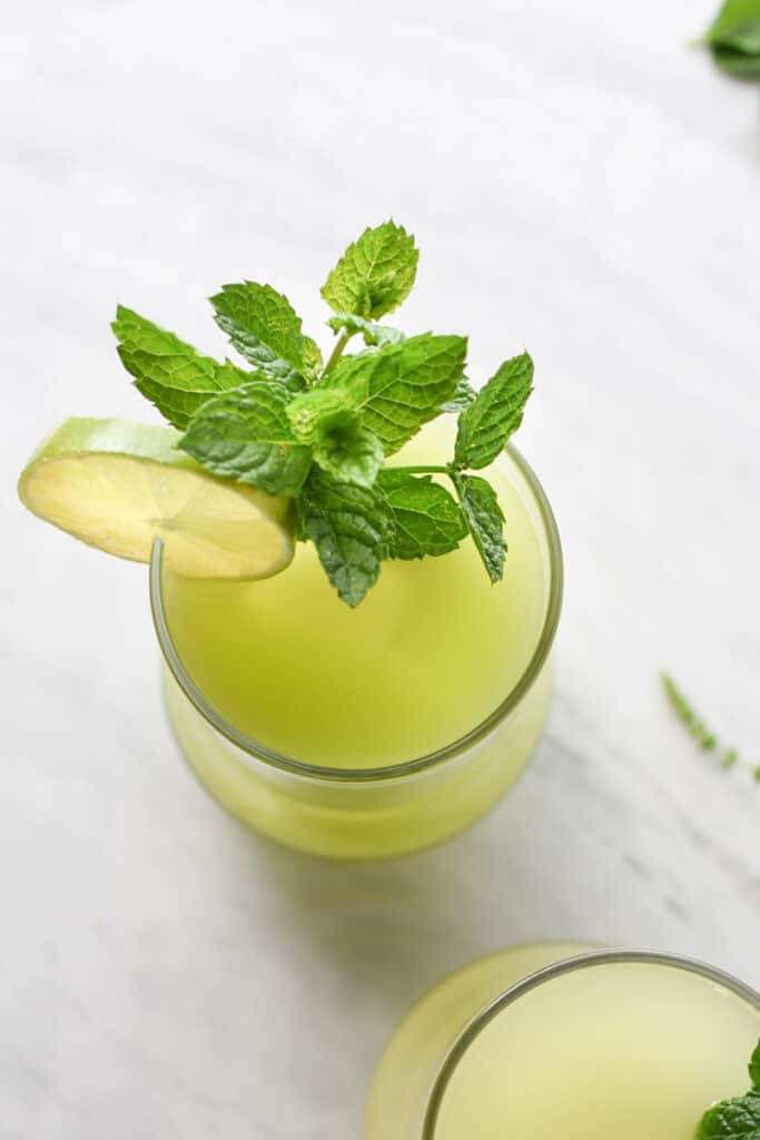 overhead shot of cucumber juice with a mint garnish