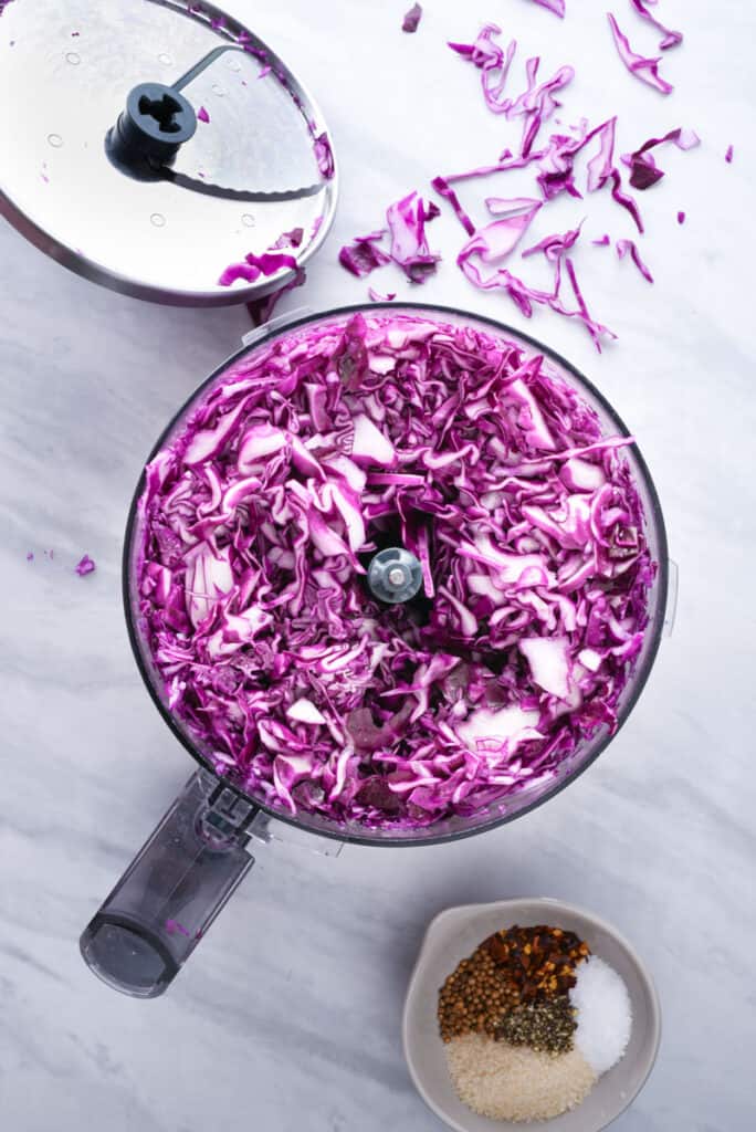 Shredded cabbage in a food processor.