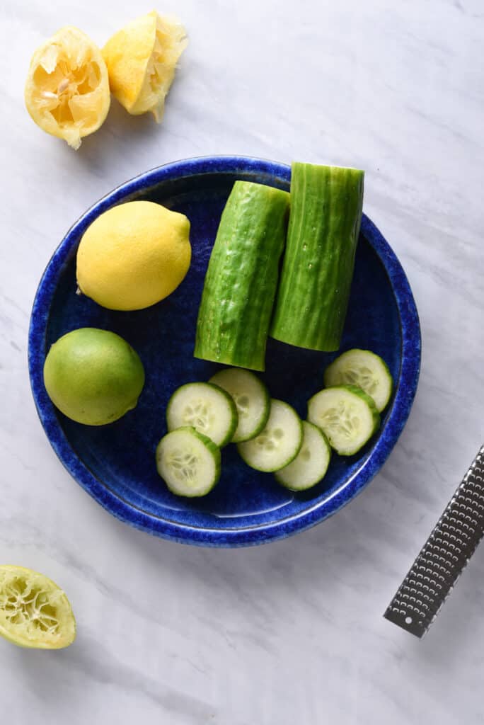 ingredients on a plate to make cucumber juice
