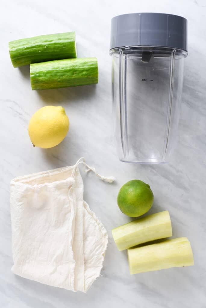 Nutribullet and nut milk bag next to cucumbers