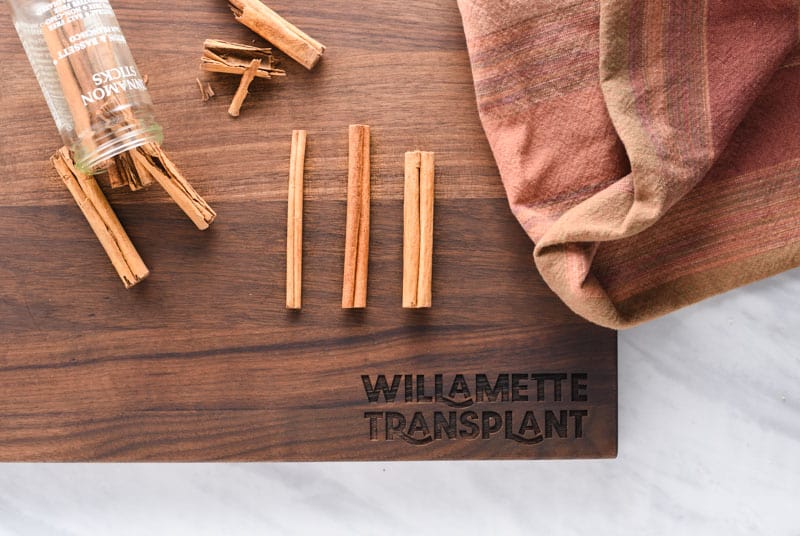 Cinnamon sticks on a cutting board.