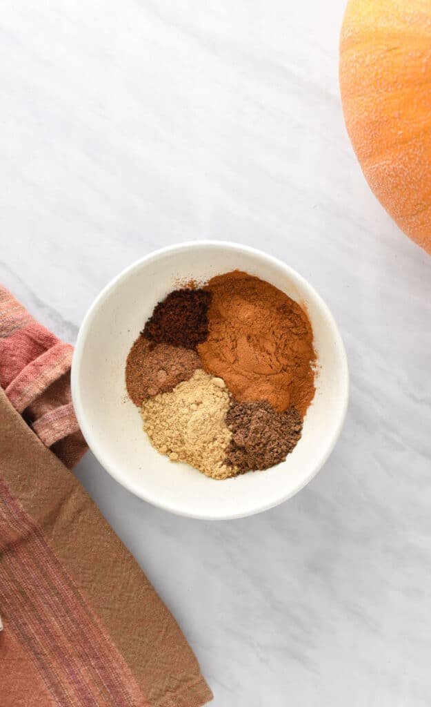 Spices in a mixing bowl to make a pumpkin spice blend.