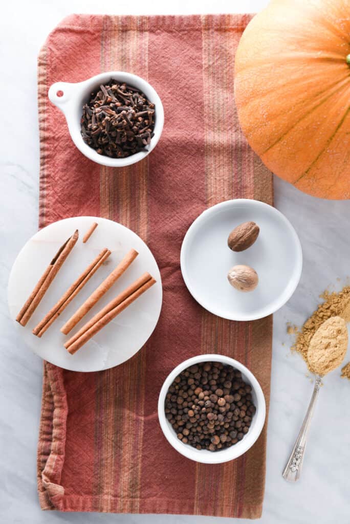 Cinnamon, ginger, nutmeg, allspice, and clove on a kitchen towel to make pumpkin spice.