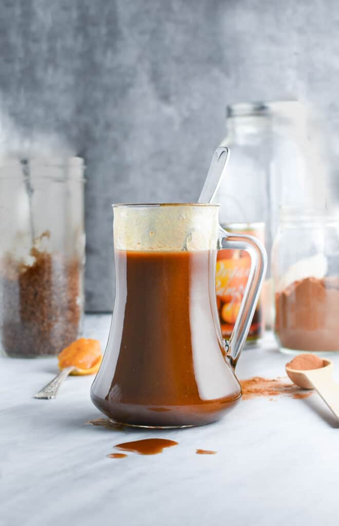 A jar full of homemade pumpkin syrup.