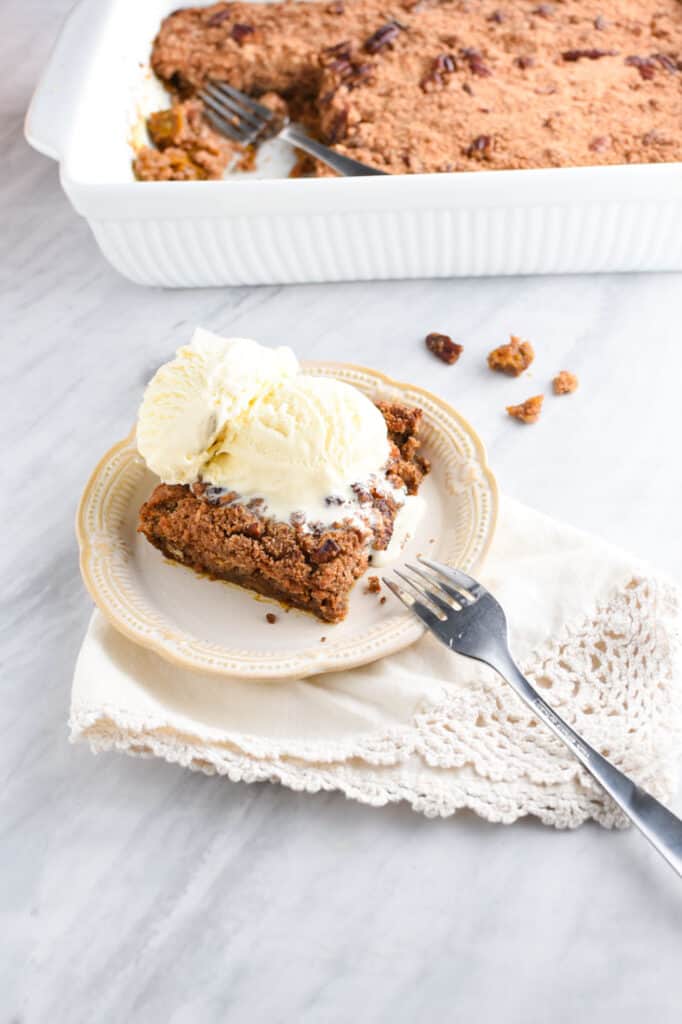 a slice of pumpkin cobbler with vanilla ice cream