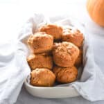 Vegan pumpkin muffins in a towel on the counter.