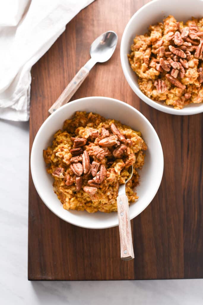 two bowls of pumpkin oatmeal on the table.