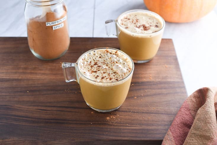 Vegan pumpkin spice latte on a cutting board