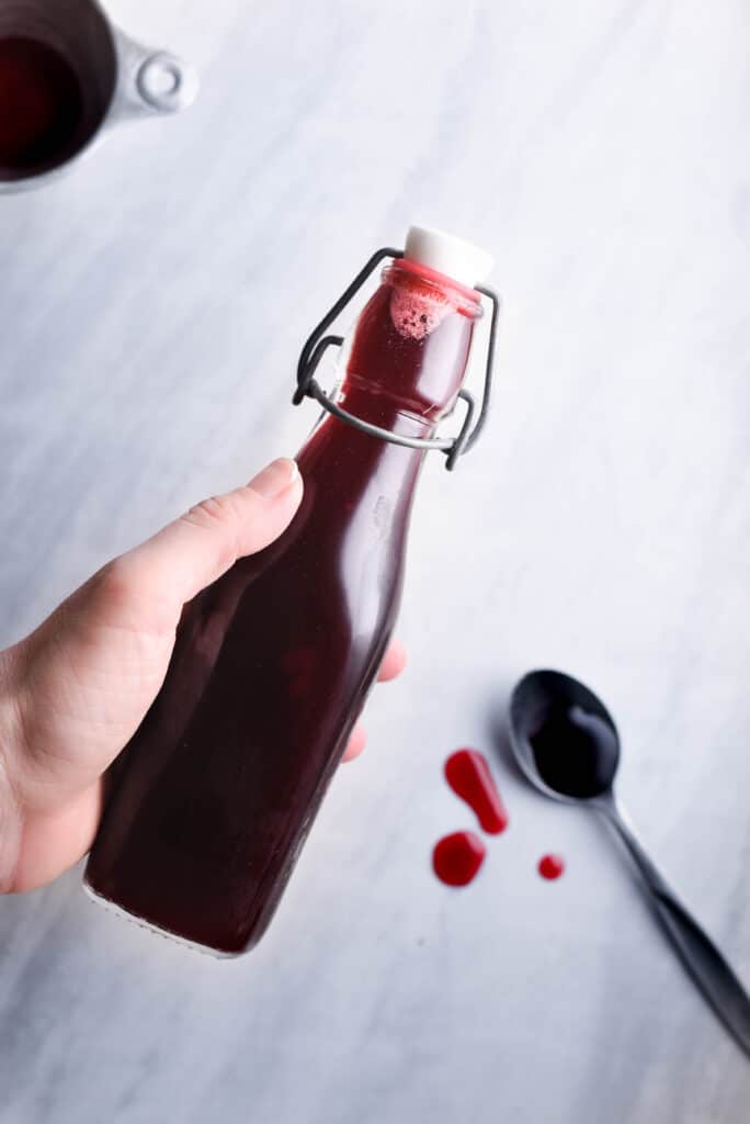 Fresh raspberry simple syrup in a jar.