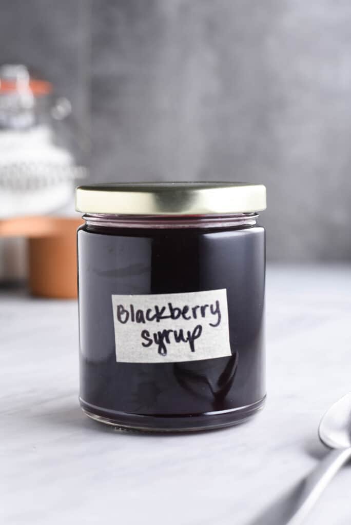 Close up shot of homemade blackberry syrup for pancakes and cocktails