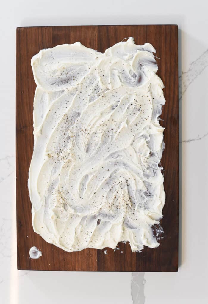vegan butter spread thinly and decoratively on a wooden board.