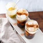 homemade starbucks pumpkin cream coffees with cinnamon sprinkled on the foam