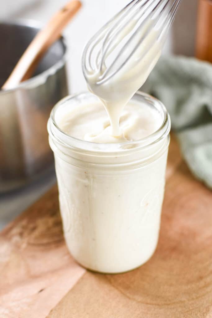 a jar of homemade vegan bechamel sauce