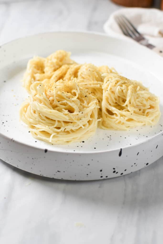 a plate of pasta tossed with bechamel sauce