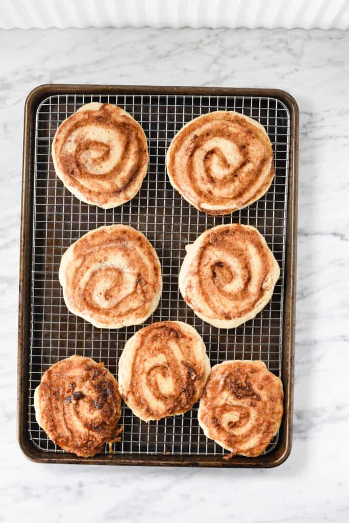 A cooling rack full of cinnamon roll pancakes.