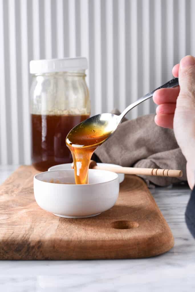 A bowl full of amber colored homemade honey.